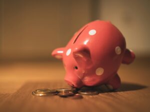 pink pig coin bank on brown wooden table