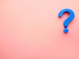 a blue question mark on a pink background